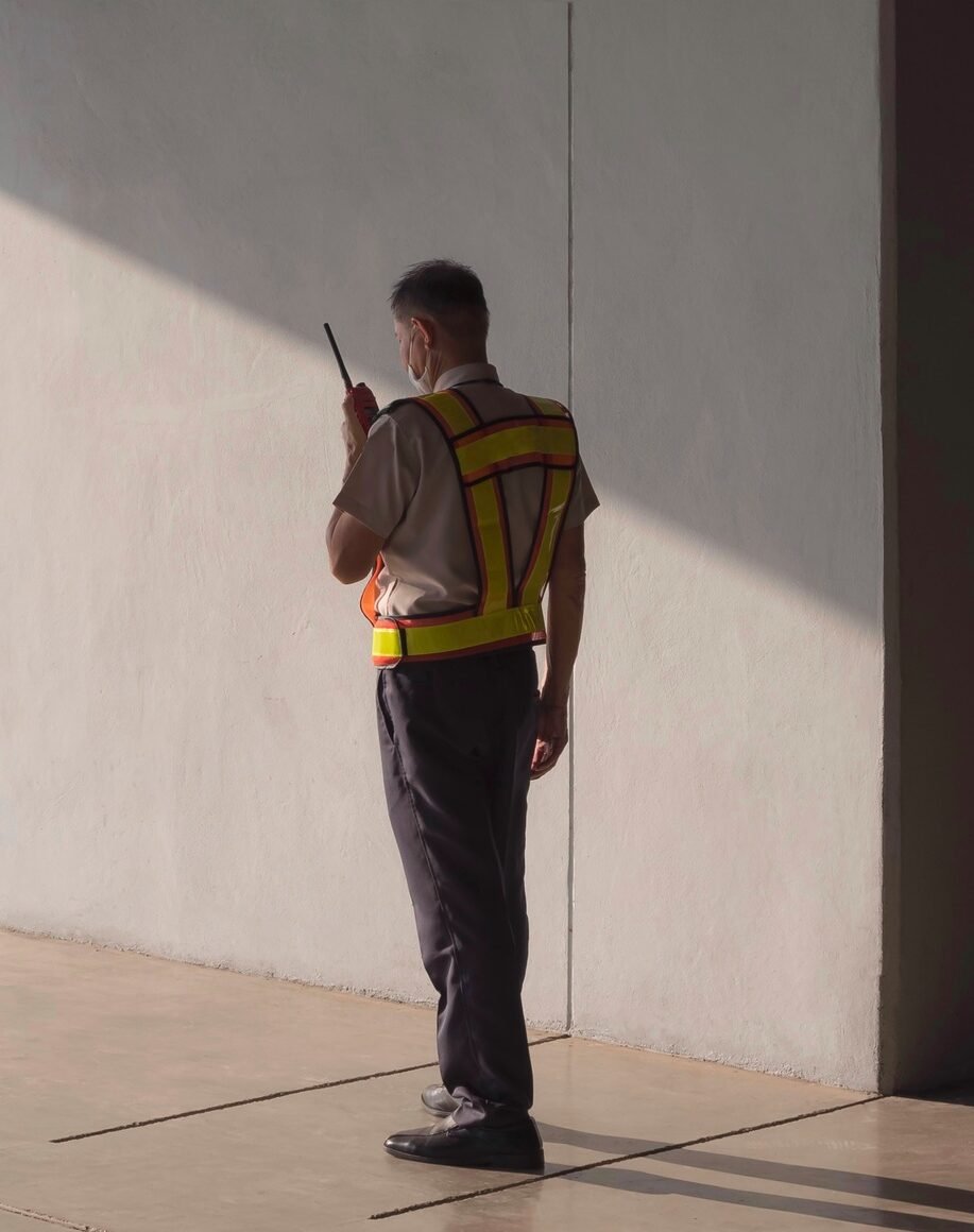 Security guard using walkie talkie while working in parking garage